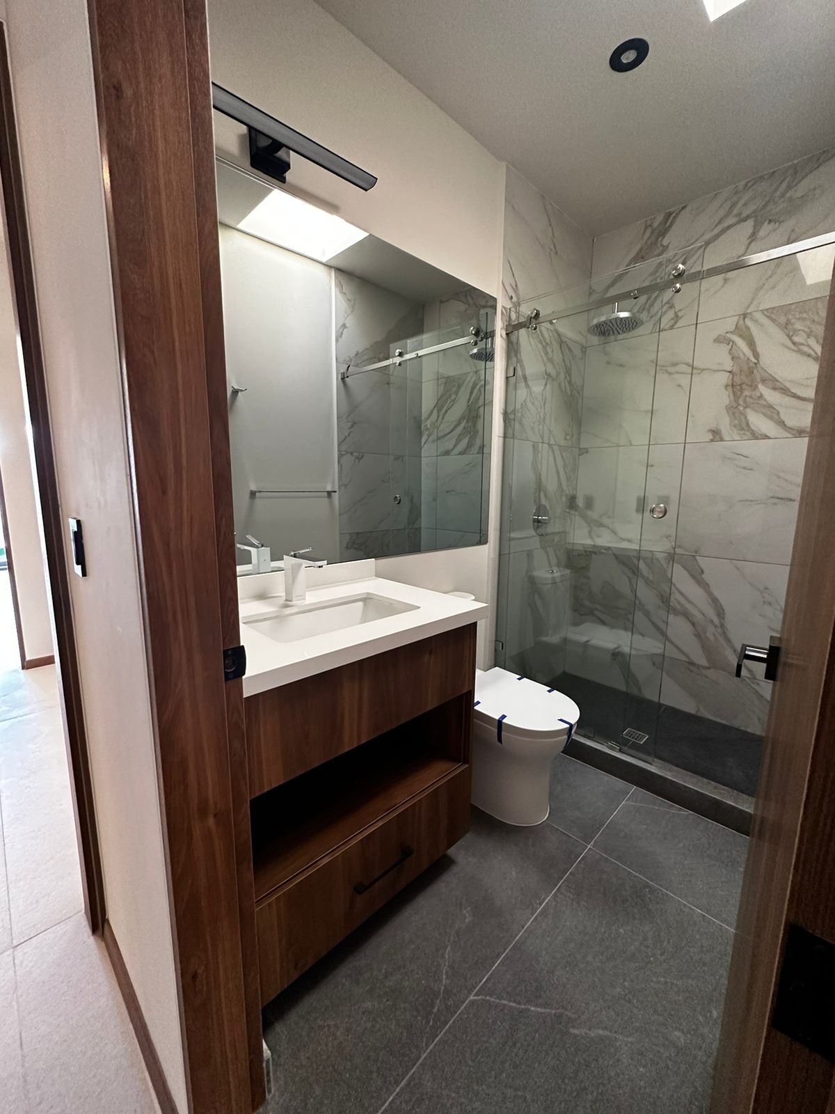 A walnut bathroom vanity supplied by Cabo