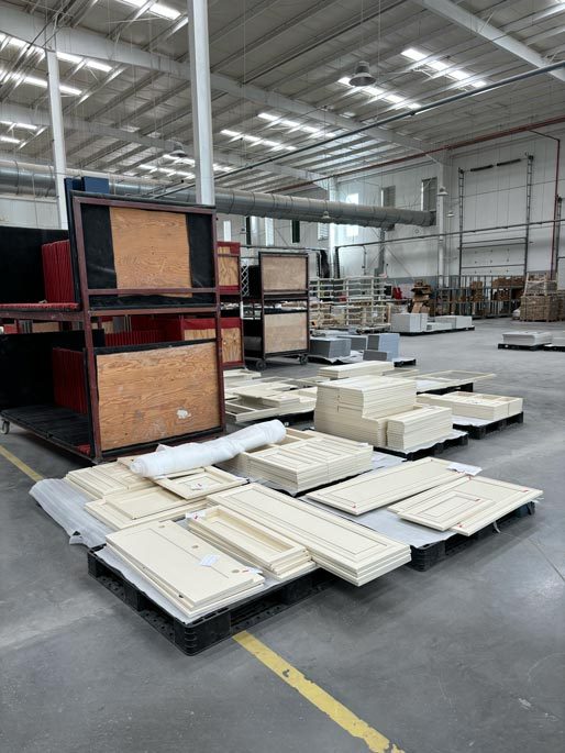 Finished cabinet doors palletised on the production floor